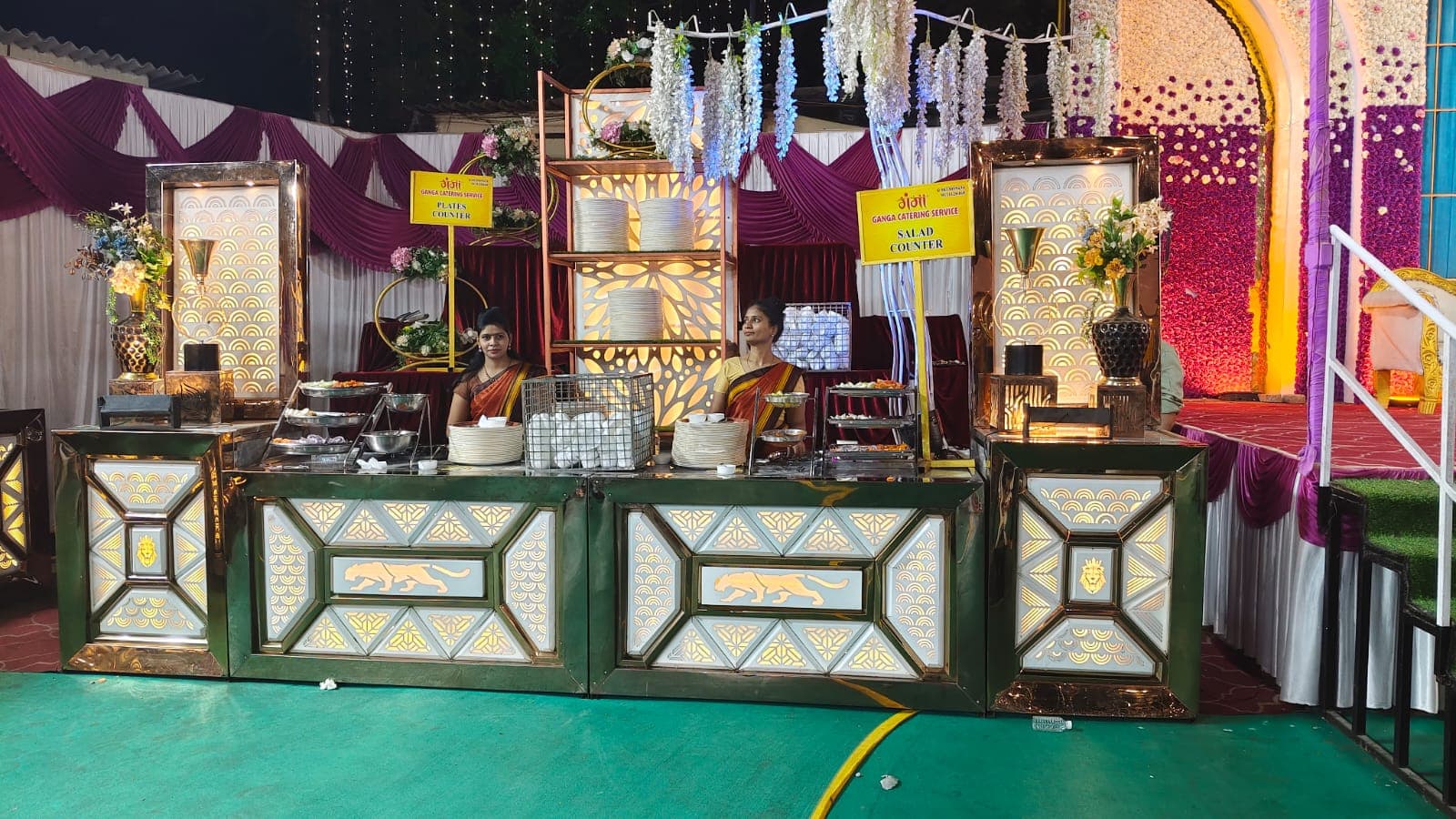 Ganga Catering Service live plates and salad counter with gold mirror finish and uniformed staff